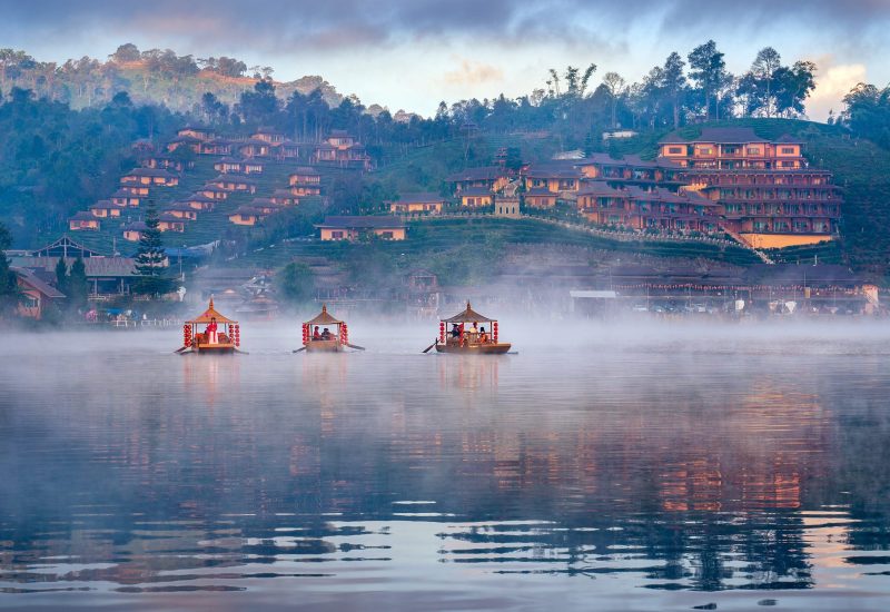Tourists take a boat at Ban Rak Thai village in Mae Hong Son pro Tourists take a boat at Ban Rak Thai village in Mae Hong Son province, Thailand.